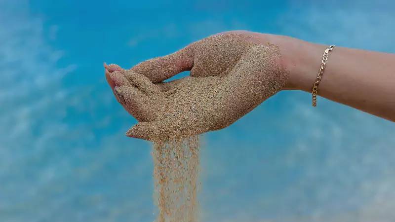 Open hand spilling sand symbolizing destiny, self-worth, and life’s unexpected paths — Siyahi Blog